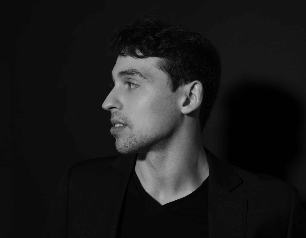 Black and white portrait of photographer Zusha Goldin
